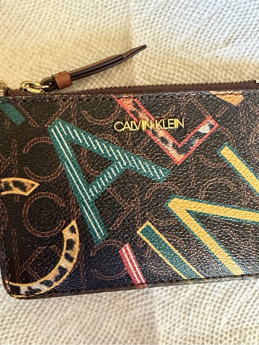 Calvin Klein Brown Leather Zip Pouch with Multicolor Graphic Letters